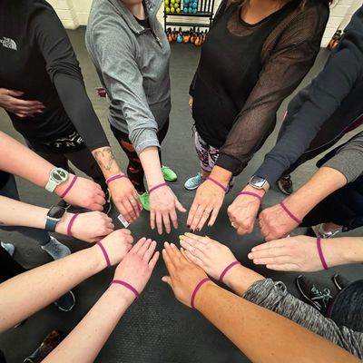 photo of hands together with little boostbands on each wrist